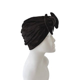 Black turban on a mannequin head against a white background