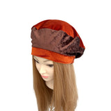 Two-tone brown hat on a mannequin head with long hair against a white background