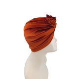 Brown turban on a mannequin head against a white background