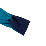 A close-up of a knotted fabric accessory, showing a two-tone design with teal on the outer side and dark navy on the inner side, set against a plain white background.