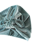 Green velvet headscarf with a knot on a white background