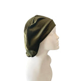 Green headscarf on a mannequin head against a white background