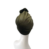 Green headscarf on a mannequin head against a white background