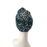 Leopard print headscarf on a mannequin head against a white background
