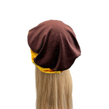 Brown hair turban with yellow interior on a white background