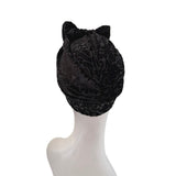 Black lace headscarf with cat ears on a mannequin head against a white background