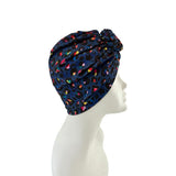 Colorful patterned headscarf on a mannequin head against a white background