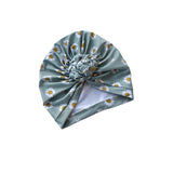Turban with daisy pattern on a white background