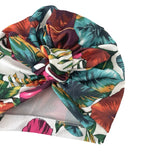 Colorful tropical leaf patterned headscarf on a white background