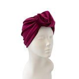 Magenta headscarf on a mannequin head against a white background
