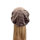 Brown velvet hair turban on a mannequin head with long blonde hair against a white background