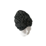 Black patterned headscarf on a mannequin head against a white background