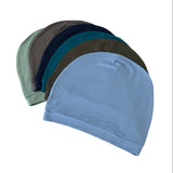 Set of four beanies in different colors on a white background