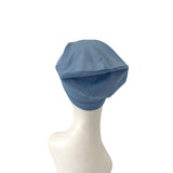 Blue headscarf on a mannequin head against a white background