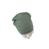 Green headscarf on a mannequin head against a white background