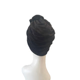 Black headscarf on a mannequin head against a white background