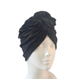 Black turban on a mannequin head against a white background