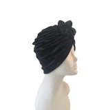 Black velvet turban on a mannequin head against a white background