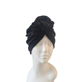 Black headscarf on a mannequin head against a white background