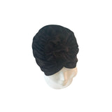 Black headscarf on a mannequin head against a white background