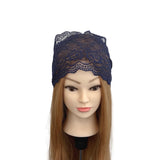 Navy lace headband on a mannequin head with long brown hair against a white background