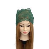 Mannequin head with green lace headband on a white background