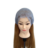 Mannequin head with a blue lace headscarf on a white background