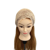 Mannequin head with a beige lace bonnet and brown hair on a white background