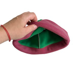 A hand wearing a red bracelet is shown lifting the edge of a fuzzy beret-style hat to reveal a bright green inner lining, against a plain white background.