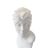 White textured headband on a mannequin head against a white background