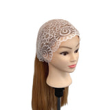 Mannequin head with a lace bonnet and brown hair on a white background