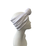 White headband on a mannequin head against a white background