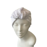white velvet headscarf on a mannequin head against a white background