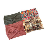 Four headbands in different patterns and colors on a white background