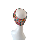 Floral patterned headscarf on a mannequin head against a white background