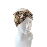 Camouflage-patterned headband on a mannequin head against a white background