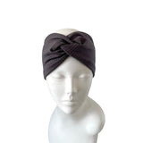 Dark gray knitted headband on a mannequin head against a white background