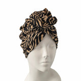Leopard print headscarf on a mannequin head against a white background