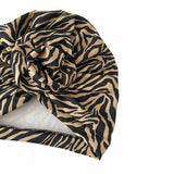 Zebra patterned headscarf on a white background
