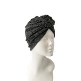 Black textured headscarf on a mannequin head against a white background